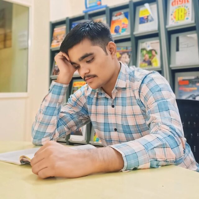 Sameer Sayyad reading in a library